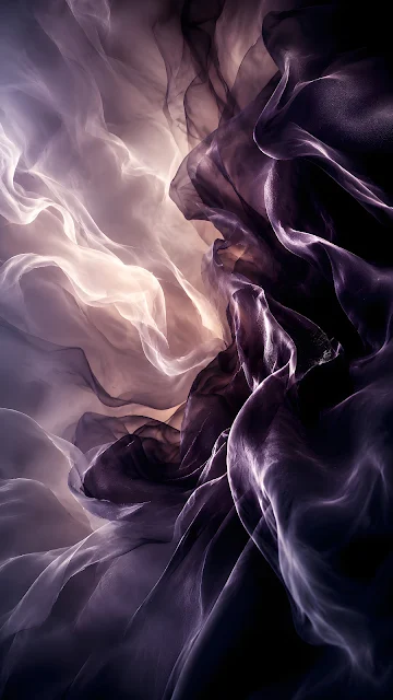 Close up of sheer translucent dark purple and silver grey silk fabric billowing in smooth, weightless folds.