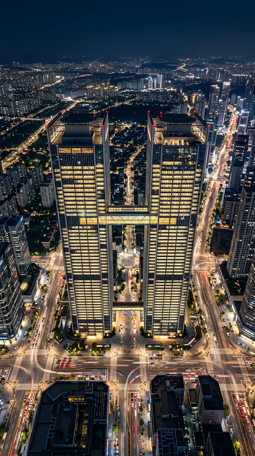 Aerial High-Angle Shot of Symmetrical Twin Skyscrapers in a Glowing Night City - Free 4K mobile Wallpaper