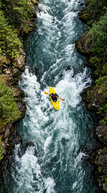 Aerial View of a Yellow Kayak in Rushing Turquoise Water - Free 4K & 8K mobile Wallpaper