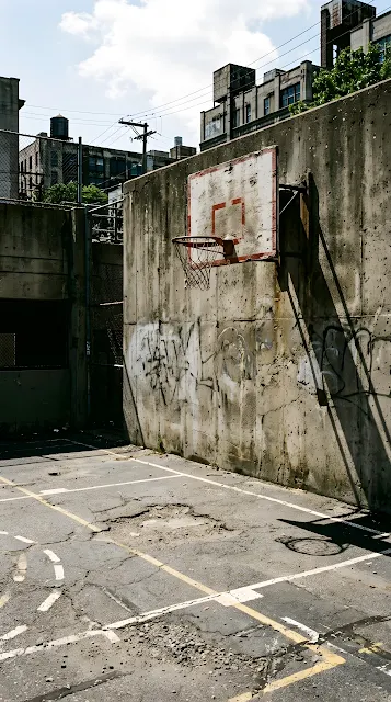 Cinematic Photo of an Urban Basketball Court with High Contrast Shadows and Light - Free mobile Wallpaper