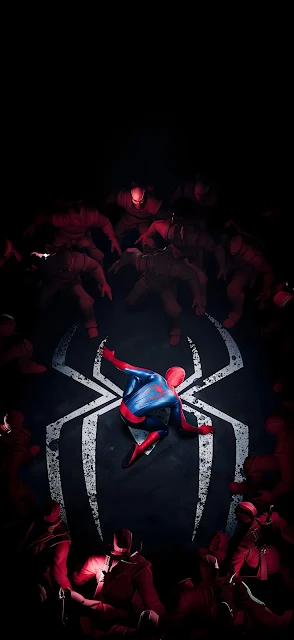 A superhero crouches at the center of a large white spider logo on the ground while surrounded by hostile shadows.