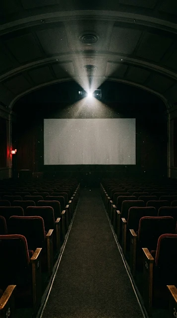 Empty Movie Theater with Projector Light and Floating Dust - Free 4K & 8K mobile Wallpaper