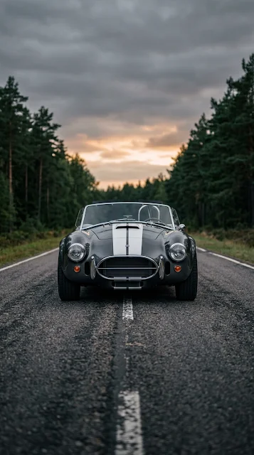 Front View of Classic Dark Grey Roadster Sports Car on Open Road - Free 4K & 8K mobile Wallpaper