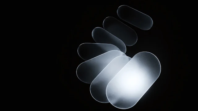 Overlapping frosted translucent glass oval shapes arranged in a spiral curve glowing softly on a black background.