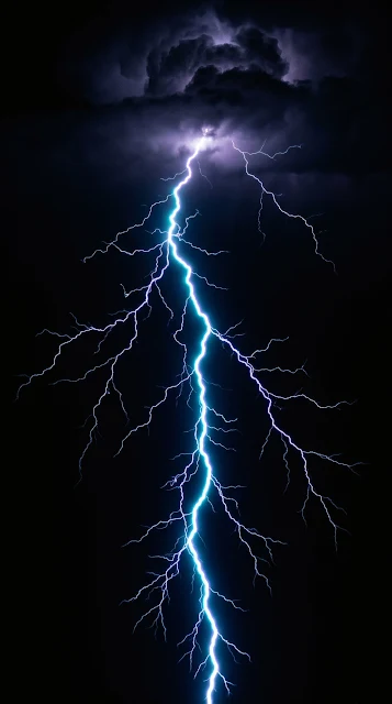 Branching electric cyan and violet lightning bolt striking down from dark storm clouds across pitch-black night.