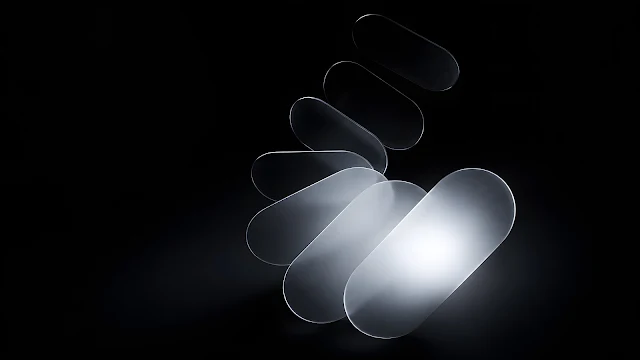 Frosted translucent glass oval plates arranged in a glowing fan arc against a pitch black background.