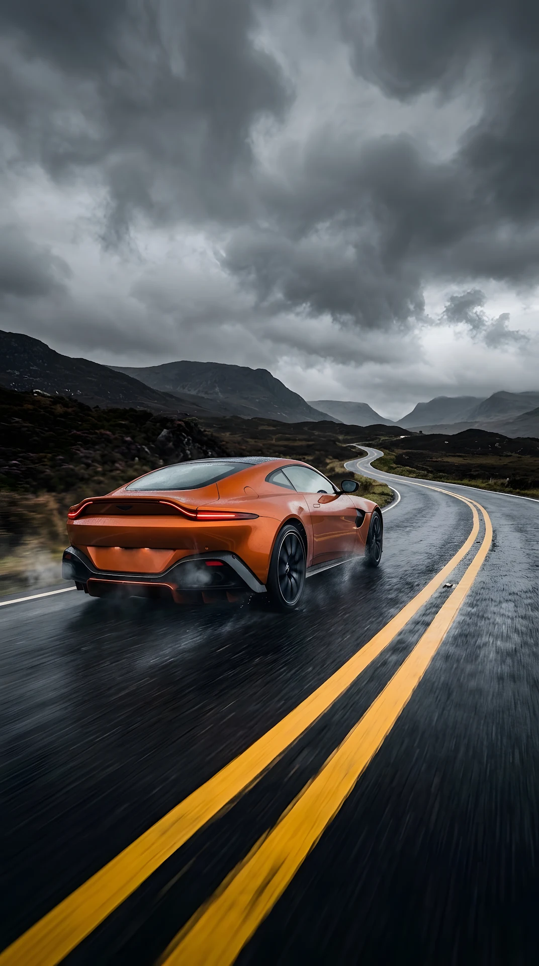 Orange High-Performance Sports Car on Dark Asphalt Road Under Stormy Clouds - Free 4K mobile Wallpaper