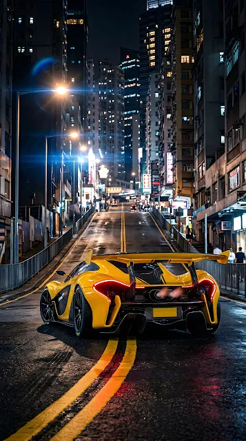Rear View of a Yellow Supercar on a Steep City Street at Night - Free mobile Wallpaper
