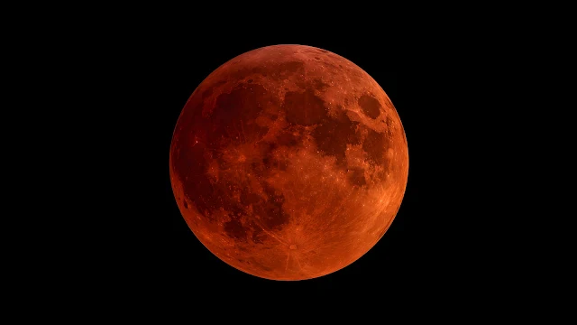 Detailed reddish-orange moon centered in a dark black night sky.