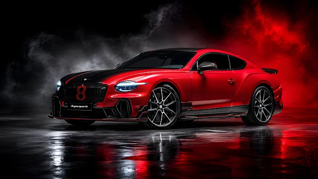 Red and black performance coupe parked on a reflective floor in a dark studio.