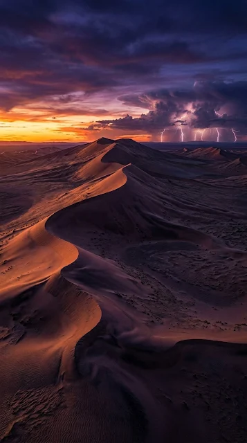Surreal Desert Landscape at Twilight with Distant Lightning Storm - Free 4K & 8K mobile Wallpaper