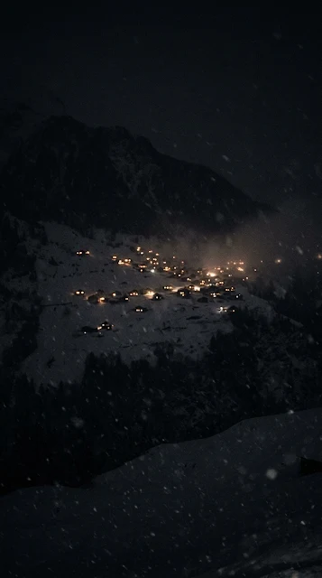 Tiny Glowing Windows in Snowy Mountain Village at Night - Free 4K & 8K mobile Wallpaper