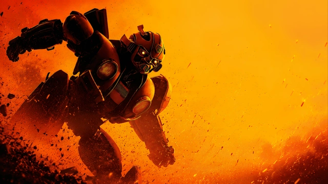 Autobot Bumblebee charging forward aggressively through flying rocky debris against an intense golden orange background.
